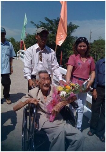 Ông lão 86 tuổi đóng quần áo nghiêm chỉnh đi khánh thành cầu và được tặng hoa.